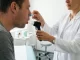 Ärztliche Untersuchung: Eine Person atmet bei einer Lungenfunktionsprüfung in das Mundstück eines Spirometers.